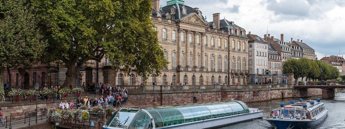 The Palais Rohan seen from the Ill, with tour boats
