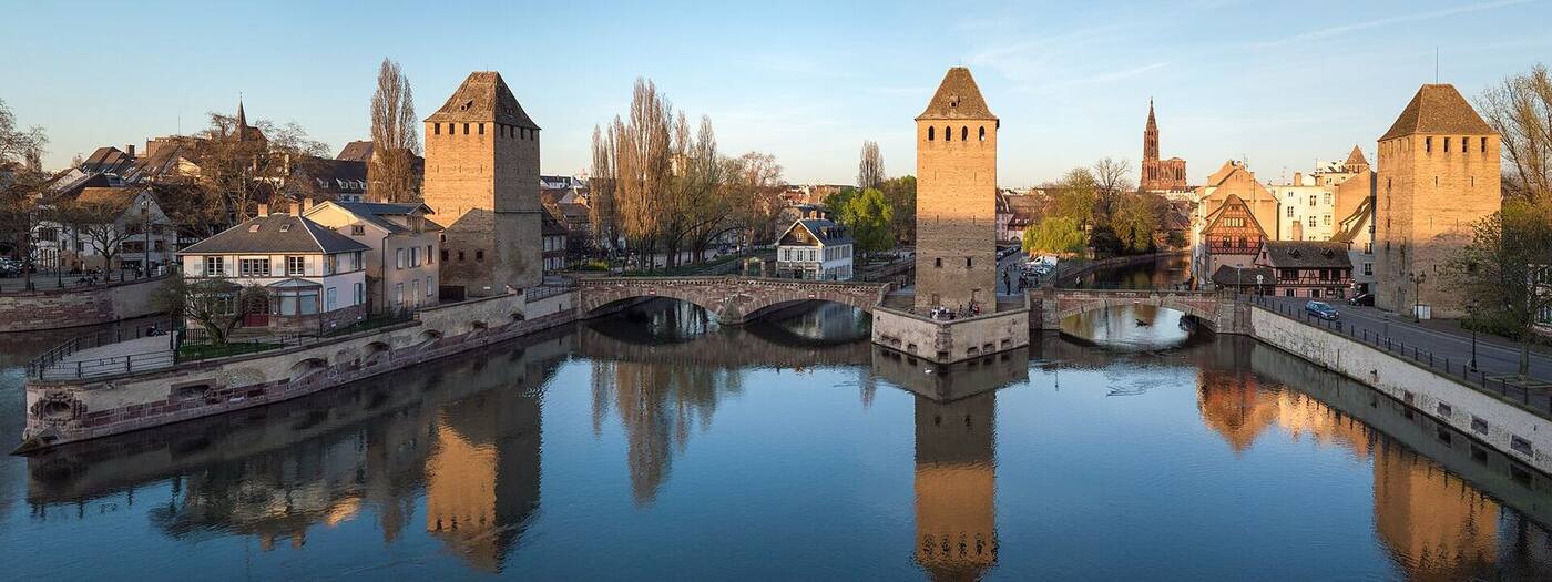 The Ponts Couverts and their towers reflected in the Ill at sunset
